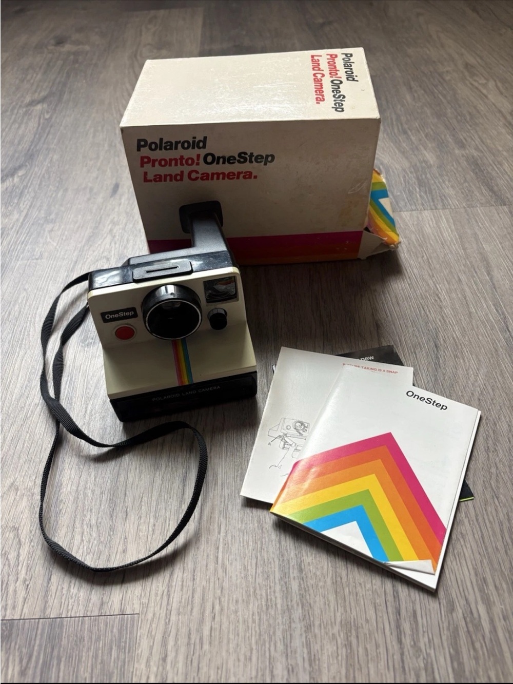 Polaroid OneStep Land Camera — cream body with rainbow stripe